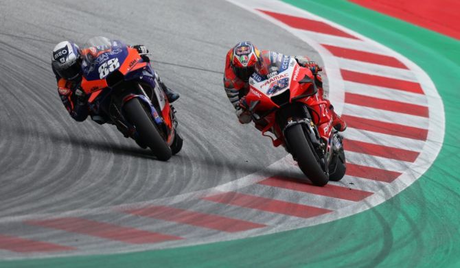 Red Bull KTM Tech 3's Miguel Oliveira and Alma Pramac Racing's Jack Miller race on the last lap of the race 