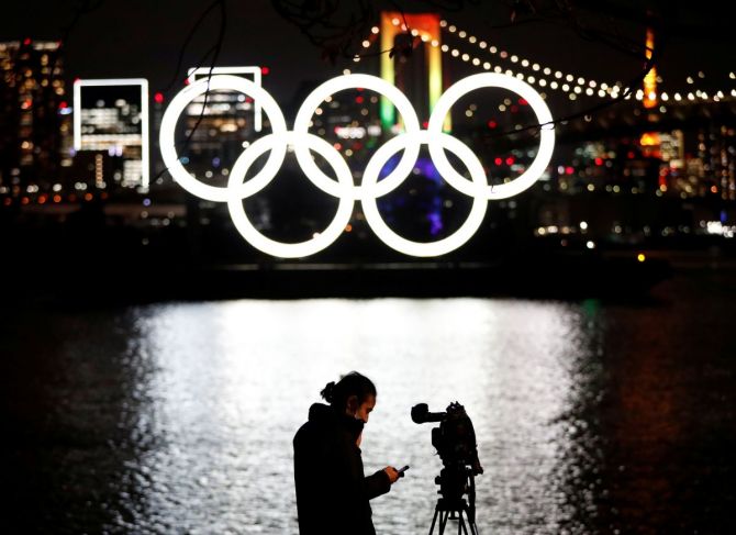 The giant Olympic rings which were temporarily taken down in August for maintenance are illuminated after being reinstalled at the waterfront area at Odaiba Marine Park, amid the coronavirus disease (COVID 19) outbreak, in Tokyo on Tuesday