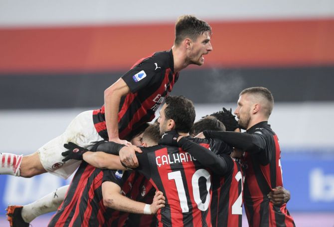 AC Milan's Franck Kessie celebrates scoring their first goal with teammates 