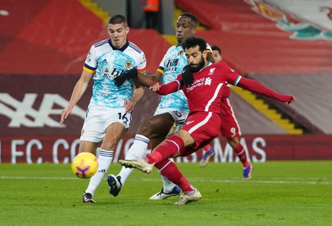 Liverpool's Mohamed Salah scores their first goal against Wolverhampton Wanderers at Anfield