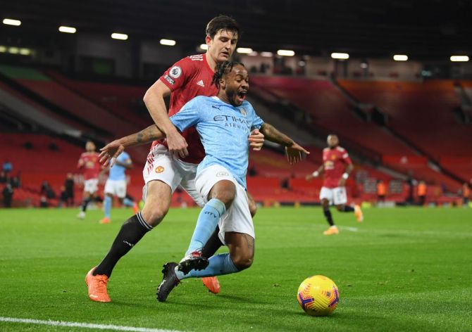 Manchester City's Raheem Sterling is challenged by Manchester United's Harry Maguire during their match at Old Trafford in Manchester 