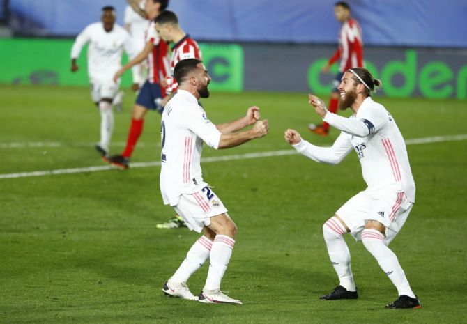Real Madrid's Dani Carvajal celebrates with Sergio Ramos after Atletico Madrid's Jan Oblak scores an own goal during their La Liga match at Estadio Alfredo Di Stefano, Madrid on Saturday