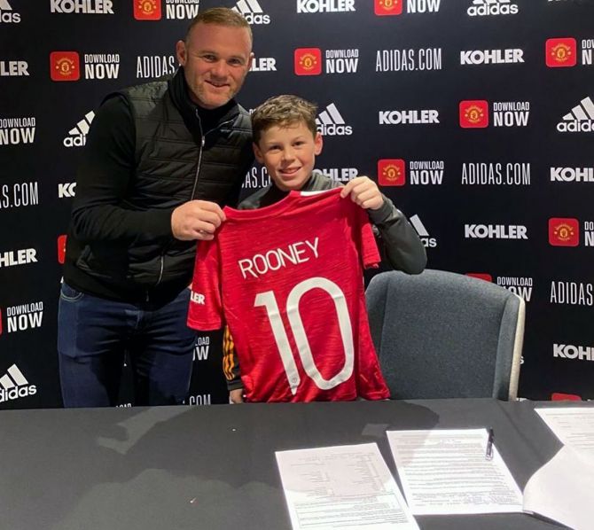 Wayne Rooney and son Kai show off the Manchester United No. 10 jersey