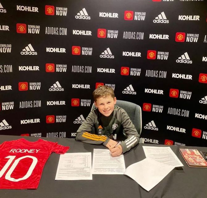 Kai Rooney signs on the dotted line for Manchester United