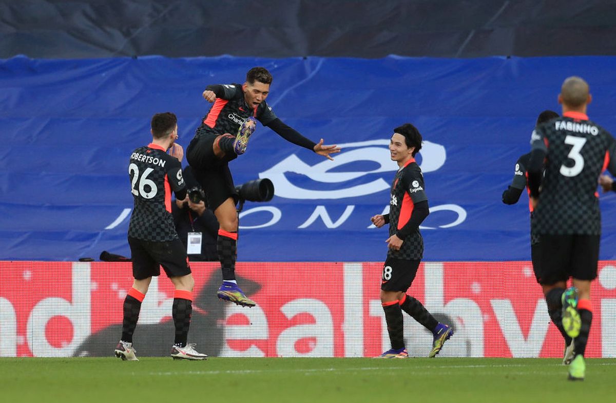 Liverpool's Roberto Firminho celebrates with Andy Robertson and Takumi Minamino after scoring the third goal against Crystal Palace at Selhurst Park in London on Saturday