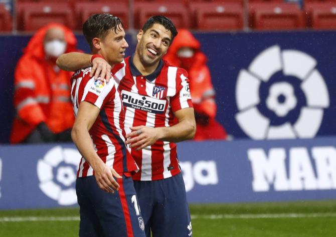 Atletico Madrid's Luis Suarez celebrates scoring their second goal with teammate Marcos Llorente during their La Liga match against Elche at Wanda Metropolitano in Madrid on Saturday. 