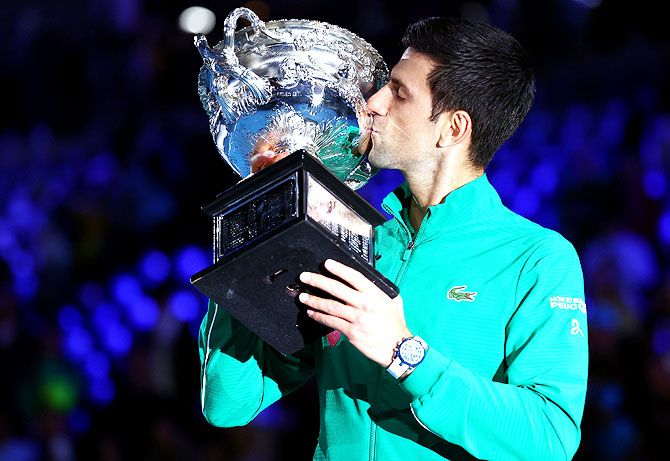 Novak Djokovic kisses the Norman Brookes Challenge Cup after winning a record-extending eighth Australian Open title