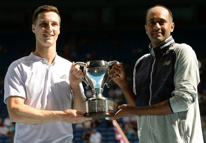 Rajeev Ram of the United States and Joe Salisbury of Great Britain hold aloft the men's doubles trophy at the Australian Open on Sunday.