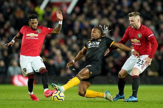 Wolverhampton Wanderers's Adama Traore makes a vain bid to get past Manchester United's Fred and Luke Shaw