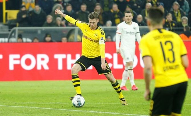 Lukasz Piszczek scores Borussia Dortmund's first goal against Eintracht Frankfurt during Friday's Bundesliga match. 