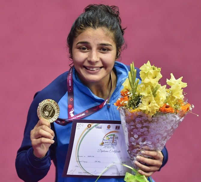 Sarita Mor shows off her gold medal following victory over Mongolia's Battsetseg Altantsetseg in the womens 59kg bout at the Asian Wrestling Championships in Delhi.. 