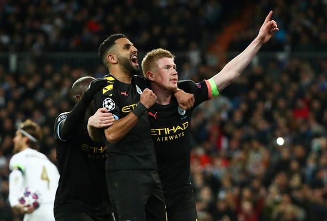 Kevin De Bruyne celebrates with Riyad Mahrez and Benjamin Mendy after scoring Manchester City's second goal in the Champions League Round of 16 First Leg against Real Madrid,