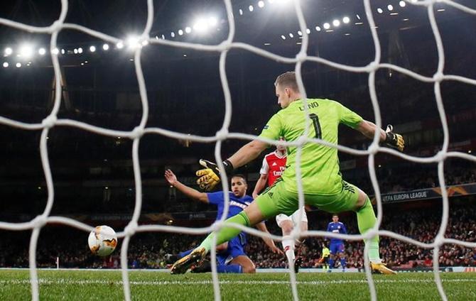 Youssef El-Arabi scores Olympiacos's second goal in the Europa League Round of 32 Second Leg against Arsenal