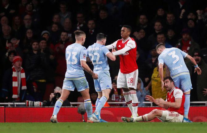 Arsenal's Joe Willock clashes with Leeds United's Jack Harrison