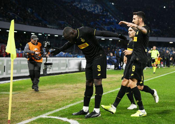 Inter Milan's Romelu Lukaku celebrates with teammates after scoring their second goal against Napoli at Stadio San Paolo in Naples on Monday