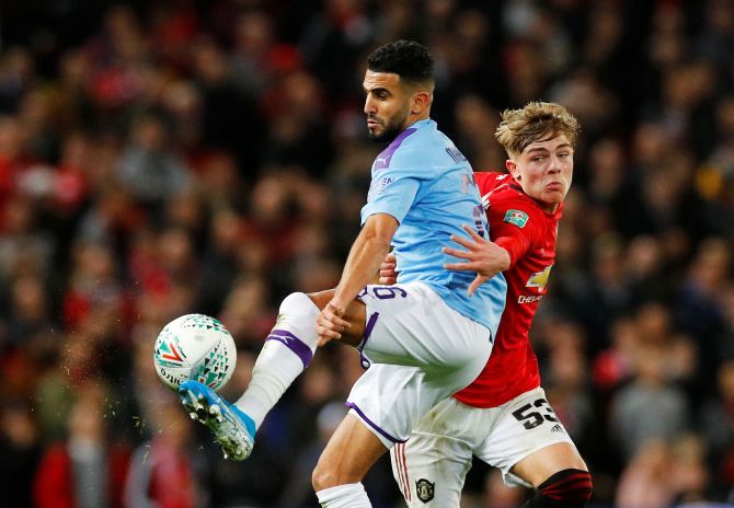 Manchester City's Riyad Mahrez and Manchester United's Brandon Williams vie for possession during their FA Cup semi-final first leg match at Old Trafford in Manchester on Tuesday
