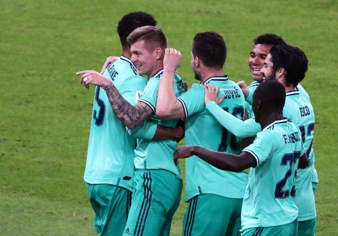 Real Madrid's Toni Kroos celebrates with teammates after scoring the opener against Valencia at the King Abdullah Sports City in Jeddah, Saudi Arabia on Wednesday 