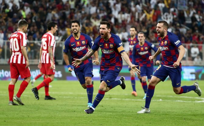 Barcelona's Lionel Messi celebrates with Jordi Alba and Luis Suarez after scoring their first goal against Atletico Madrid