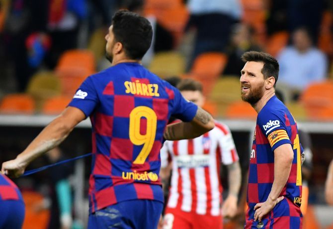 FC Barcelona's Lionel Messi and Luis Suarez look dejected after their Super Cup match loss at King Abdullah Sports City, Jeddah on Friday