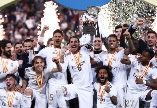 Sergio Ramos lifts the trophy as Real Madrid players celebrate winning the Super Cup title after defeating Atletico Madrid in penalties at King Abdullah Sports City, Jeddah, Saudi Arabia on Sunday