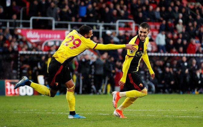 Watford's Roberto Pereyra celebrates with Etienne Capoue after scoring their third goal against Bournemouth at Vitality Stadium in Bournemouth on Sunday