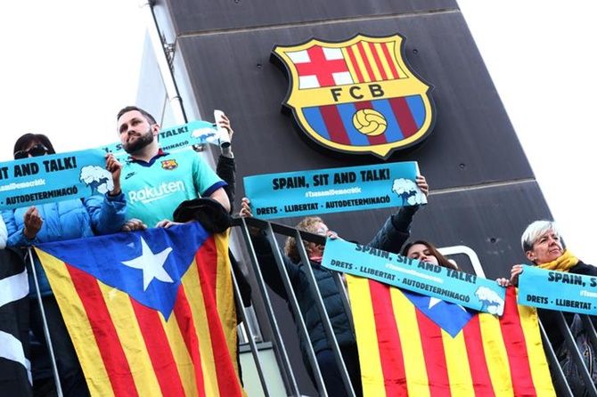 Fans display banners outside the Camp Nou stadium in Barcelona. 