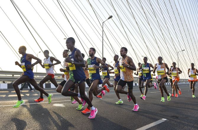 International athletes run on the Bandra-Worli Sea Link bridge during the Mumbai Marathon 2020, in Mumbai on Sunday