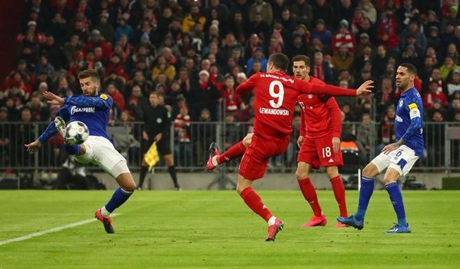 Robert Lewandowski scores Bayern Munich's first goal in the Bundesliga match against Schalke 04