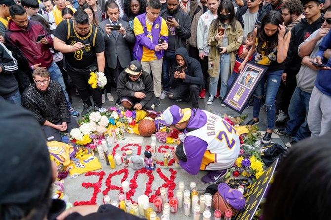 Mourners place tributes as they gather in Microsoft Square near the Staples Center to pay respects to Kobe Bryant 
