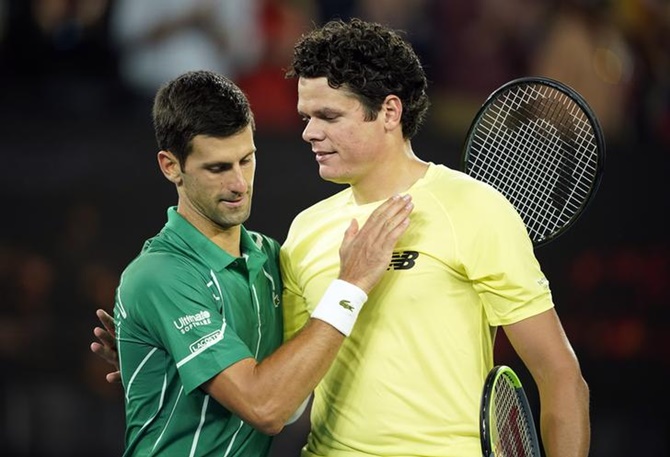 Novak Djokovic and Milos Raonic embrace after their match