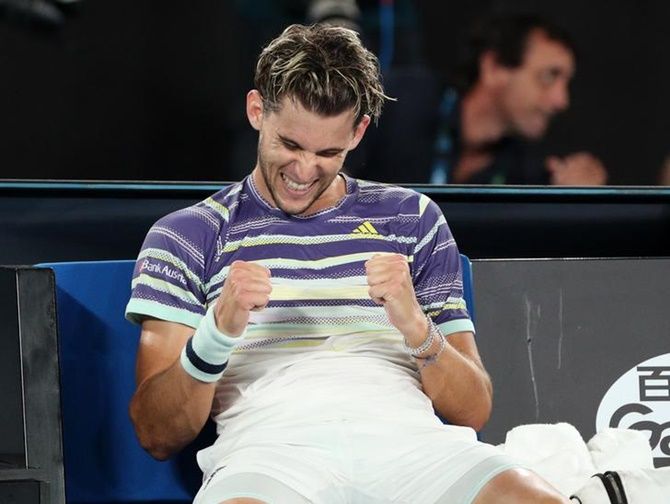 Dominic Thiem celebrates after returning to his seat following his quarter-final victory over Rafael Nadal