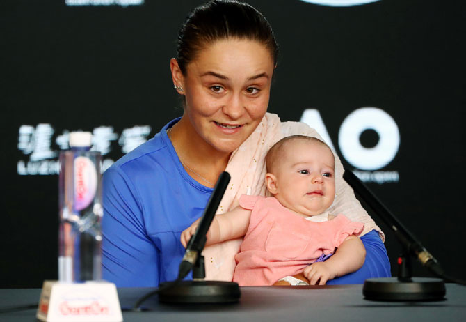 World No 1 Ashleigh Barty holds her niece Olivia during a press conference after losing her semi-final match against Sofia Kenin at this year's Australian Open.