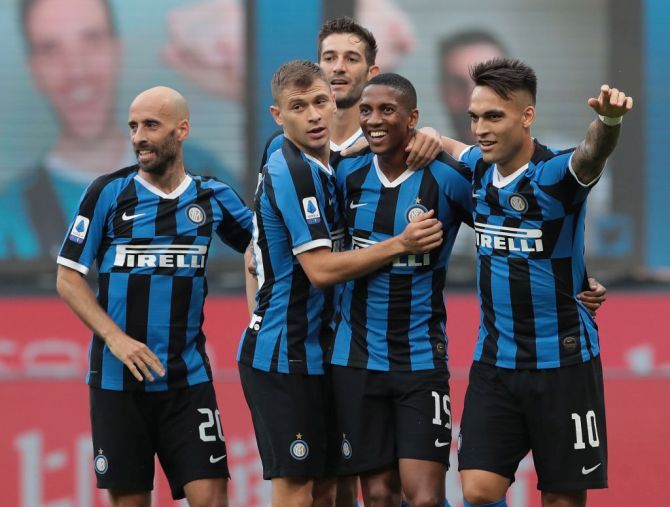 Inter Milan's Ashley Young (centre) celebrates with teammates after scoring their opening goal against Brescia Calcio during their Serie A match at Stadio Giuseppe Meazza in Milan, Italy