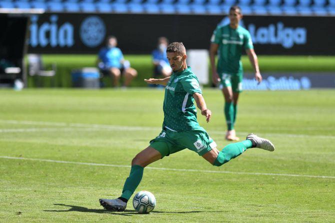 Real Betis' Zouhair Feddal shoots to score against Celta Vigo during their La Liga match