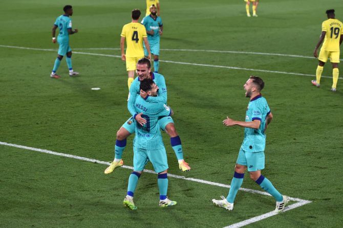 Barcelona's Antoine Griezmann celebrates with Lionel Messi after scoring the third goal against Villarreal CF at Estadio de la Ceramica in Villareal, Spain.