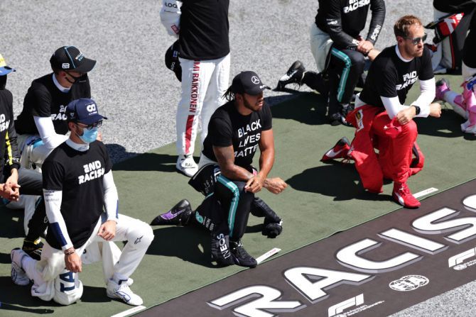 Mercedes GP's British driver Lewis Hamilton and Scuderia AlphaTauri's French driver Pierre Gasly among other F1 drivers take a knee on the grid in support of the Black Lives Matter movement ahead of the Formula One Grand Prix of Austria at Red Bull Ring in Spielberg, Austria, on Sunday