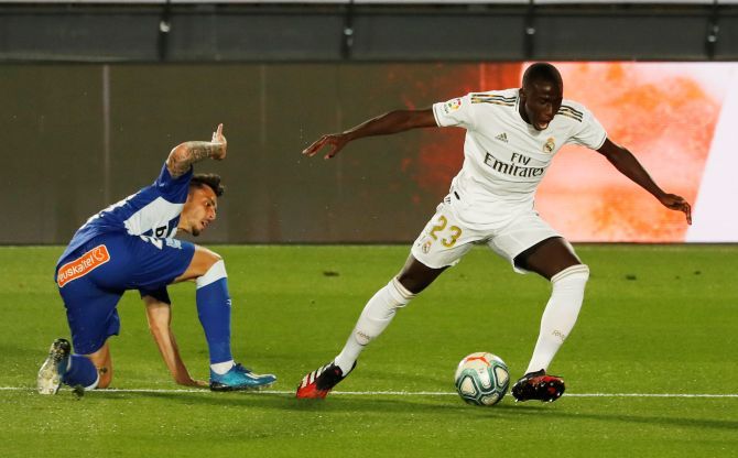 Real Madrid's Ferland Mendy wins the ball in a challenge against Alaves' Edgar Mendez
