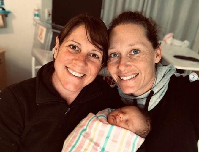 Sam Stosur (right) with her partner Liz and their newborn Genevieve 