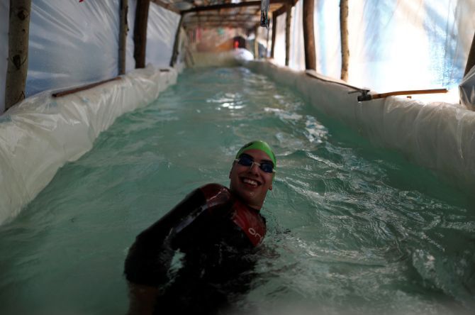 Sebastian Galleguillo, a paralympic swimmer who suffers from hearing loss, trains in the swimming pool his family built for him, during the outbreak of the coronavirus disease (COVID-19), in Florencio Varela, on the outskirts of Buenos Aires in Argentina