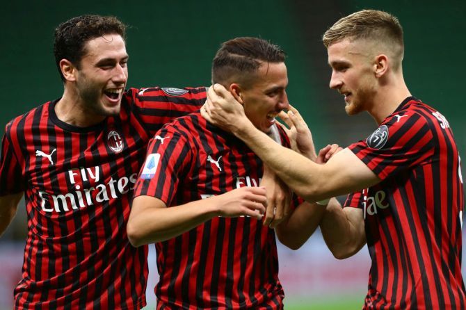 AC Milan's Ismael Bennacer (centre) celebrates his goal with his teammates Alexis Saelemaekers (right) and Davide Calabria (left) during their Serie A match against Bologna FC at Stadio Giuseppe Meazza in Milan, Italy, on Saturday