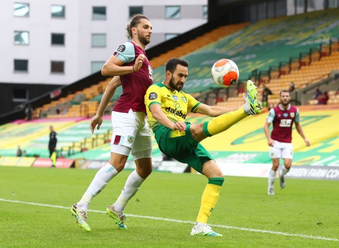 Burnley's Jay Rodriguez and Norwich City's Lukas Rupp vie for possession during their English Premier League match at Carrow Road, Norwich, Britain, on Saturday 
