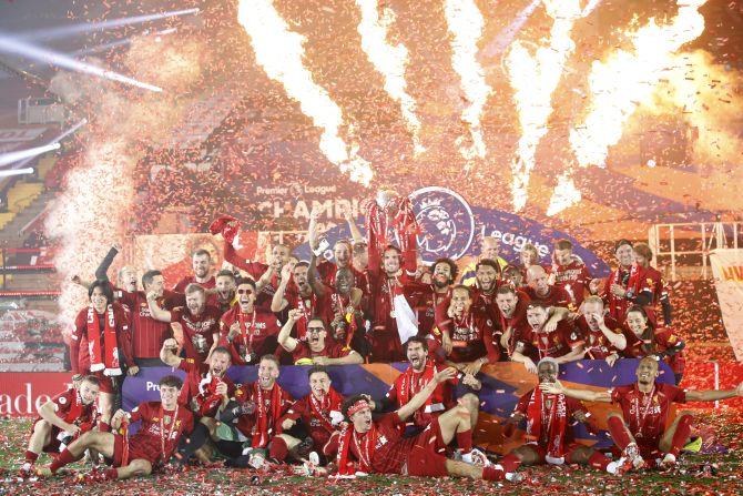 Liverpool players celebrate with the trophy 