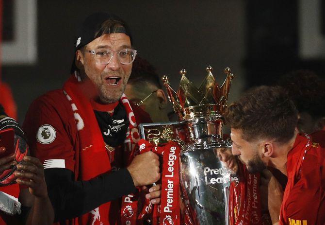 Liverpool manager Juergen Klopp celebrates with the trophy