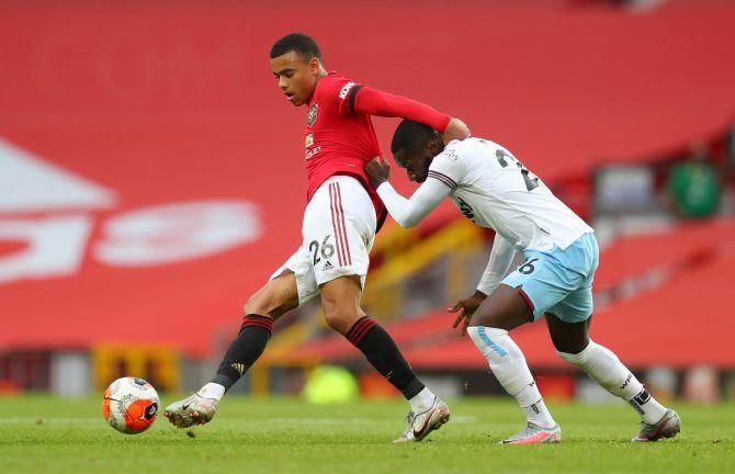 anchester United's Mason Greenwood in action with West Ham United's Arthur Masuaku