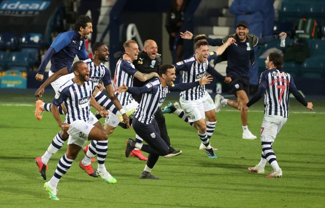 West Bromwich Albion players celebrate promotion to the Premier League after the match against Queens Park Rangers at The Hawthorns in West Bromwich Britain