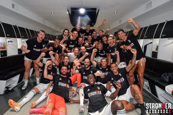 Juventus players celebrate their Serie A title win in the dressing room