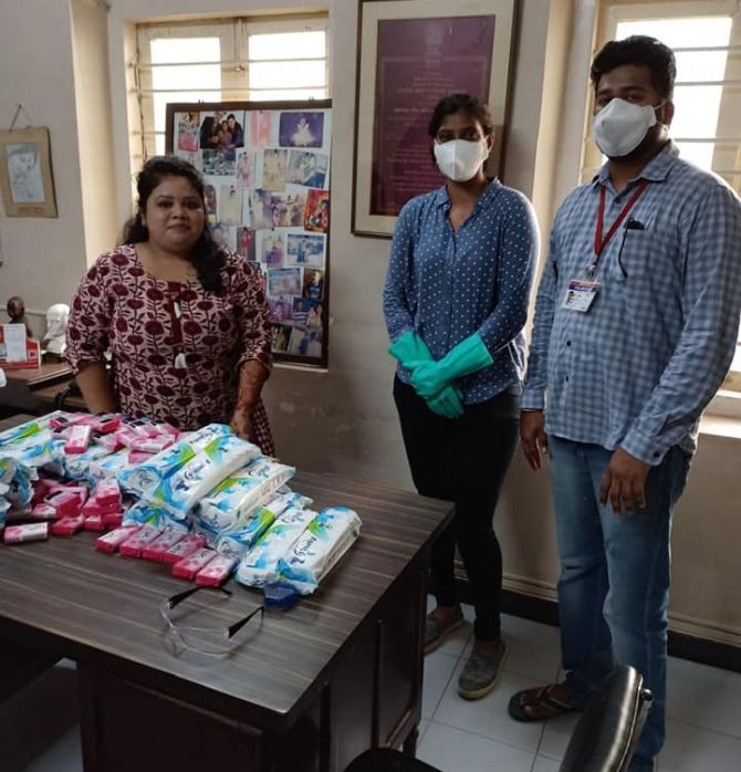 Sweta Shervegar (centre) donates sanitary napkins and soaps to a children's shelter home in South Mumbai