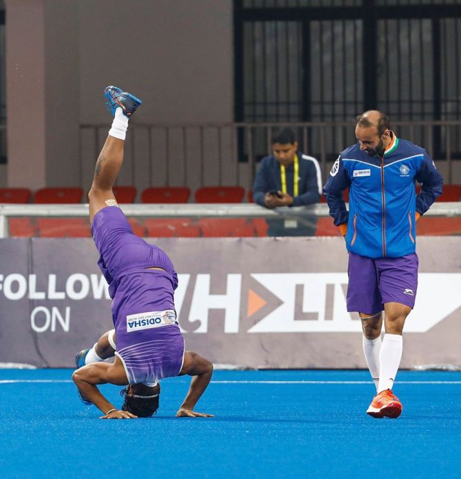 Ramandeep Singh attempts a headstand during a training session