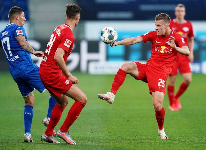 Hoffenheim's Steven Zuber in action with Leipzig's Dani Olmo during their Bundesliga match at PreZero Arena, Sinsheim, Germany, on Friday