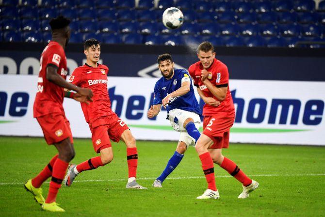 Schalke's Daniel Caligiuri in action with Leverkusen's Sven Bender during their Bundesliga match at Veltins-Arena, Gelsenkirchen, Germany, on Sunday 